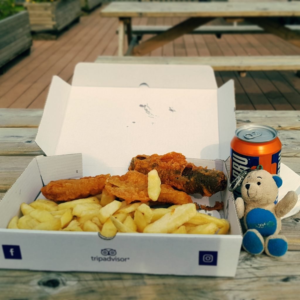 Photo of Teddy enjoying take out from The Seaforth chipper.